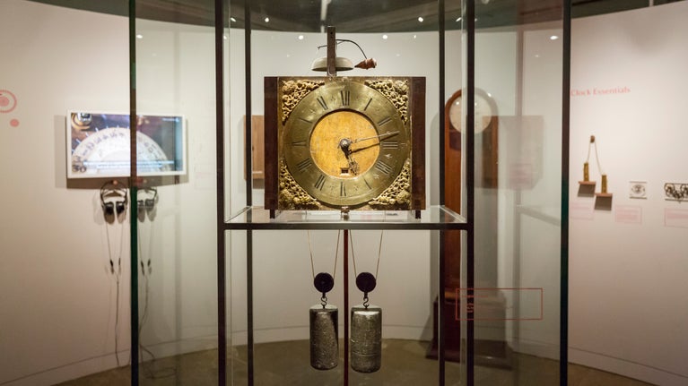 An 18th century wooden clock made by John Harrison's in a glass cabinet at Nostell